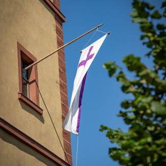 Fahne mit Kreuz am Kirchturm